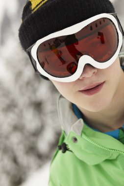 Teenage Boy Wearing Ski Goggles On Ski Holiday In Mountains clipart