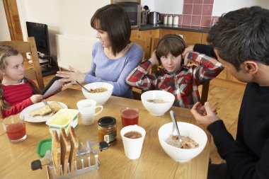 Parents Taking Away Gadgets From Children Whilst Eating Breakfas clipart