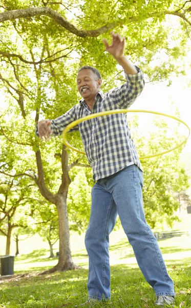 Senior man with hula-hoop — Stock Photo, Image