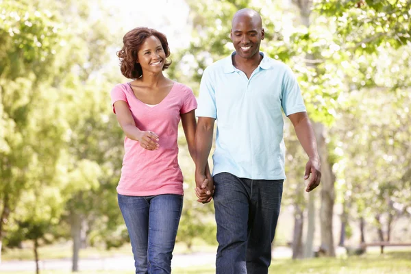 Young couple walking in park — Stock Photo, Image