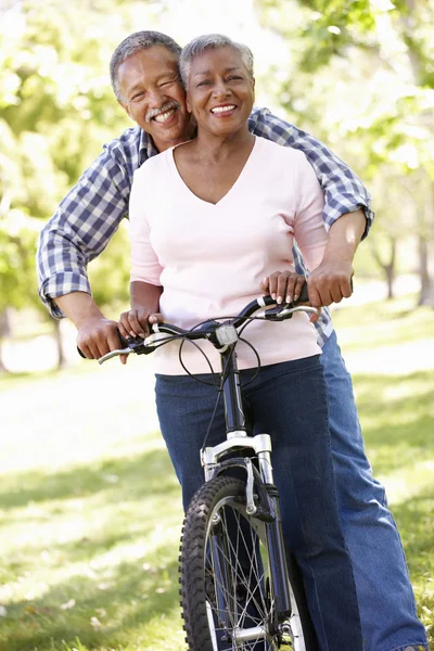 Äldre par cykling i park — Stockfoto