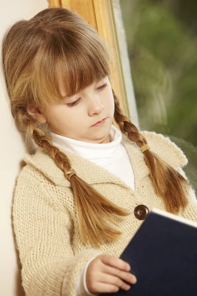 Giovane ragazza seduta sul sedile in legno libro di lettura — Foto Stock