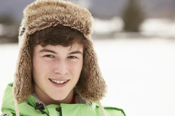 Portrait Of Teenage Boy In Snow Wearing Fur Hat — Stock Photo, Image