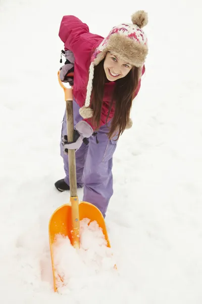 Genç kız bir yoldaki kar küremeye — Stok fotoğraf