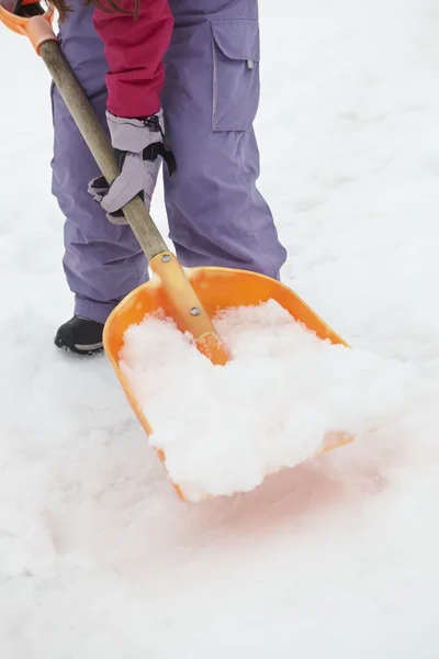 Крупним планом Підліток Дівчина лопати сніг від шляху — стокове фото