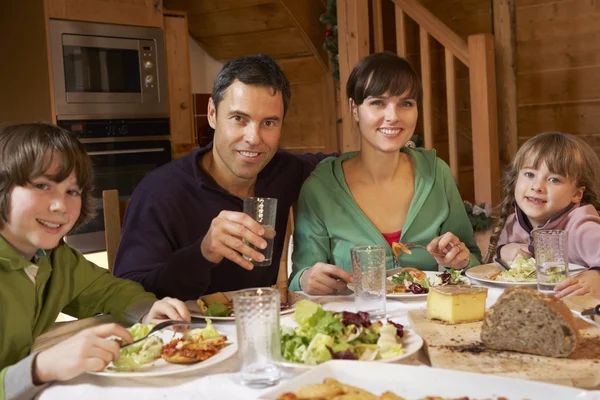 Família desfrutando de refeição em Chalé Alpino juntos — Fotografia de Stock