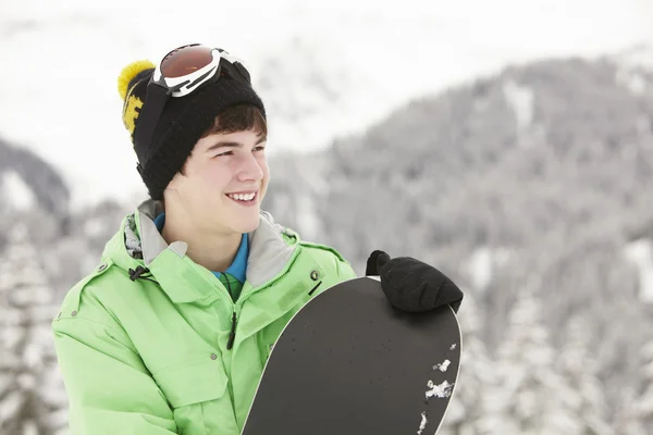 Teenage Boy With Snowboard On Ski Holiday In Mountains — Stock Photo, Image