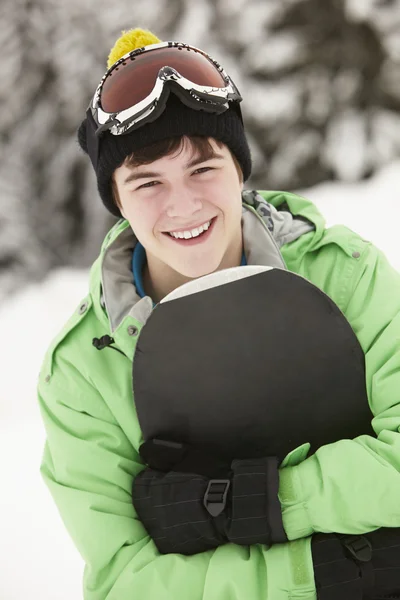 Adolescente con snowboard en vacaciones de esquí en las montañas —  Fotos de Stock