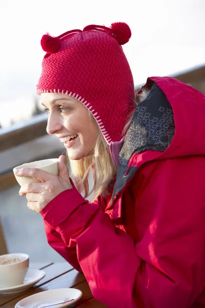 Woman Enjoying Hot Drink In Café At Ski Resort — стокове фото