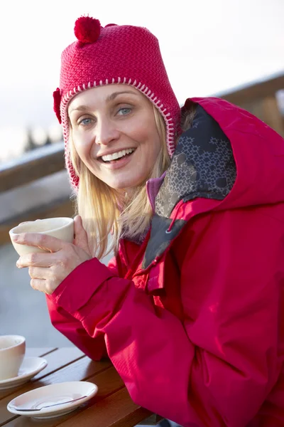Woman Enjoying Hot Drink In Café At Ski Resort — Stockfoto