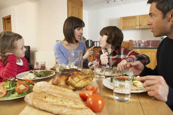 Familia teniendo un argumento mientras comen juntos en la cocina — Foto de Stock