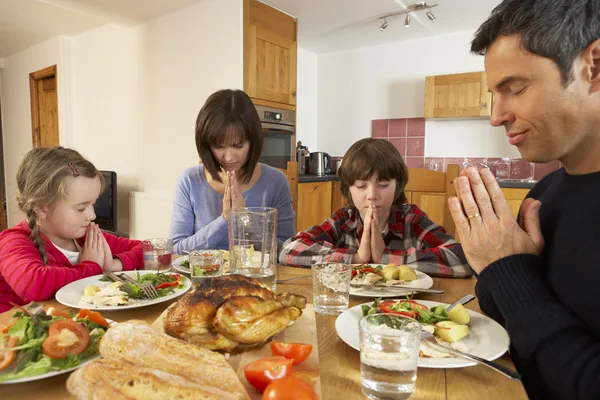 Семья произносит молитву перед обедом вместе на кухне — стоковое фото