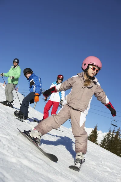 Family On Ski Holiday In Mountains Stock Photo