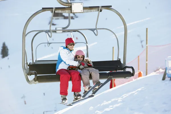 Mother And Daughter Getting Off chair Lift On Ski Holiday In Mou Royalty Free Stock Images
