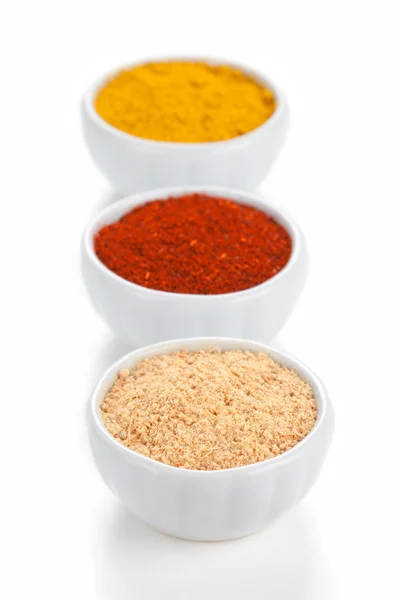 Different spices in white bowls isolated on white background. — Stock Photo, Image