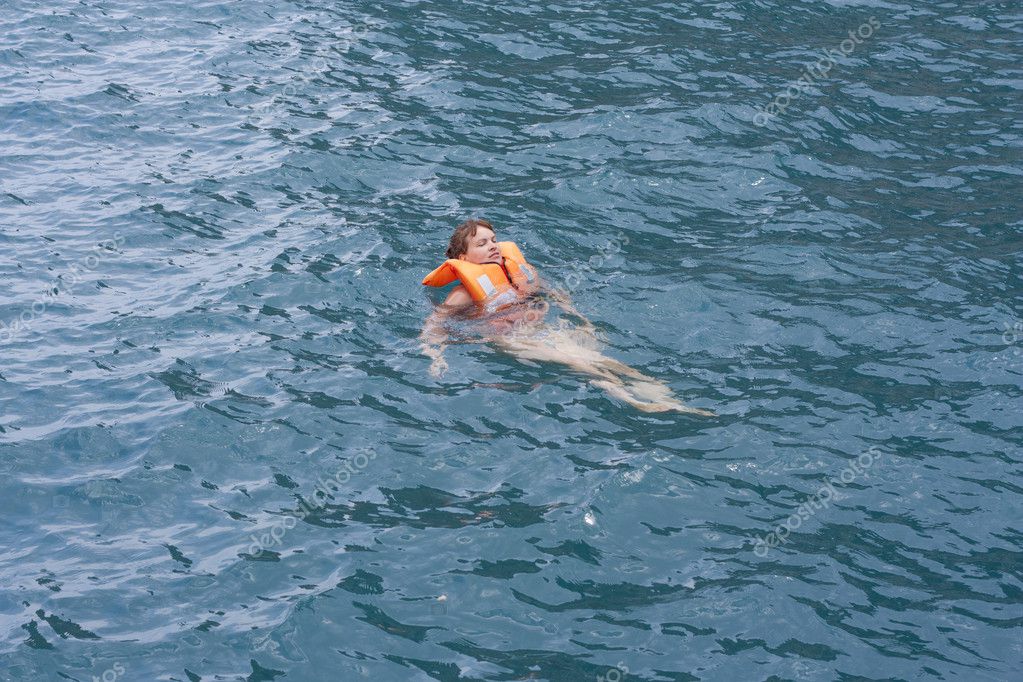 Woman In Orange Life Jacket In Water Of A Sea Stock Editorial Photo © Svetap 11155514