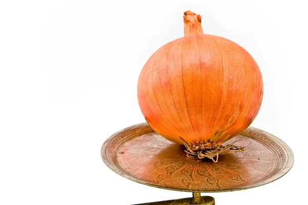 Onion on old scale plate — Stock Photo, Image
