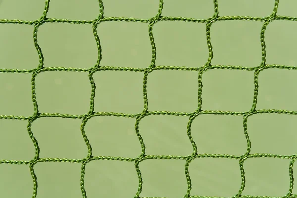 Zielony odkrytym korcie tenisowym netto jako tło — Zdjęcie stockowe