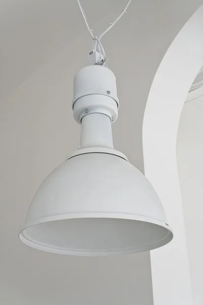 White ceiling lamp in large hall