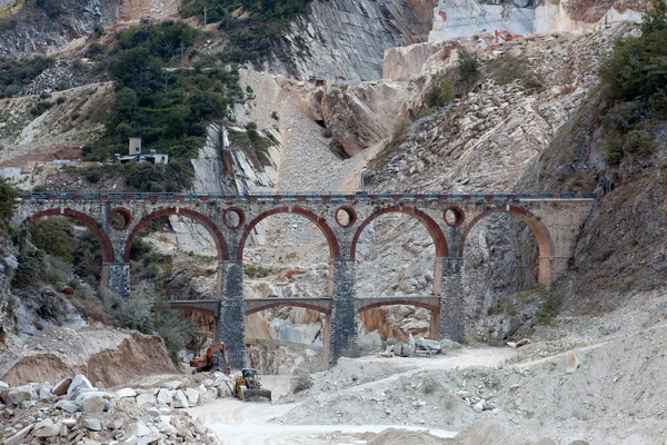 stock image White marble quarry, bridge and excavators. Apuan, Carrara, Tusc