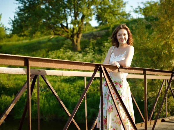 stock image The young woman costs on the bridge