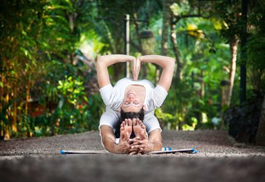 Couple yoga in garden clipart