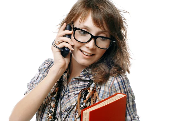 Hablando chica sostiene teléfono y libro rojo —  Fotos de Stock