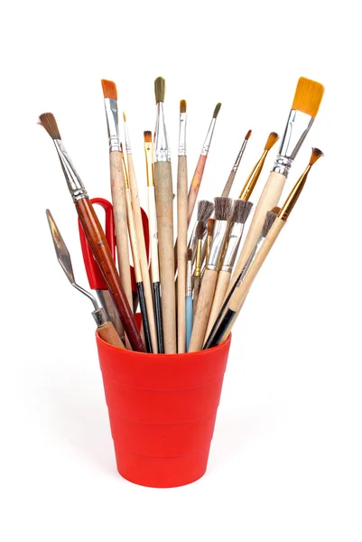 Red glass with brushes — Stock Photo, Image