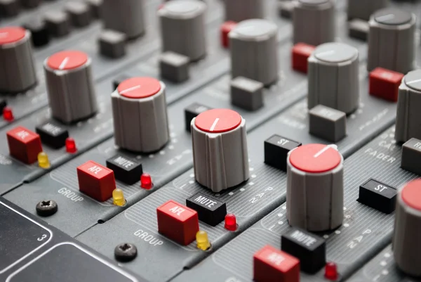 Sound mixer console with highlighted button, pump the volume — Stock Photo, Image