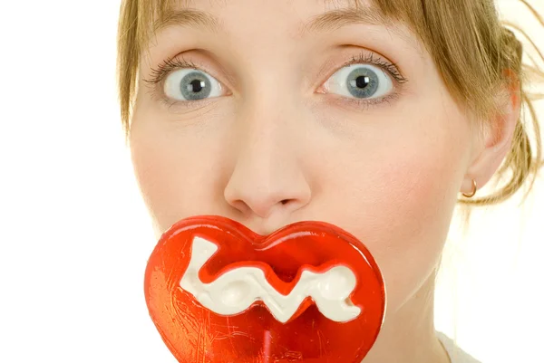 Attractive girl with candy in the form of heart — Stock Photo, Image