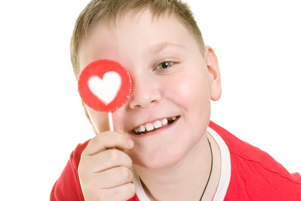 Kid with heart shaped lollipop — Stock Photo, Image