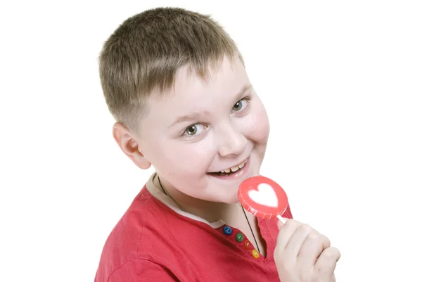 Kid with heart shaped lolly pop — Stock Photo, Image