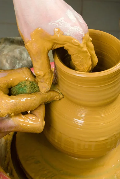 Hands of a potter, creating an earthen jar of yellow clay — Stock Photo, Image