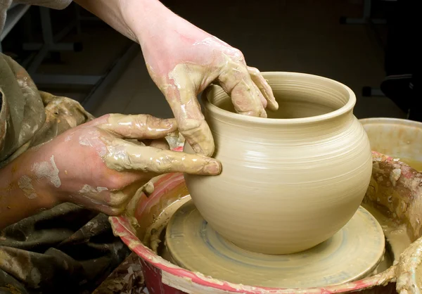 Handen van een pottenbakker, maken een aarden pot van witte klei — Stockfoto