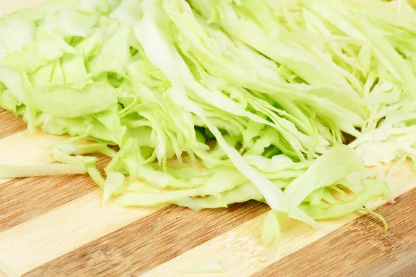 Green cabbage sliced on cutting board — Stock Photo, Image