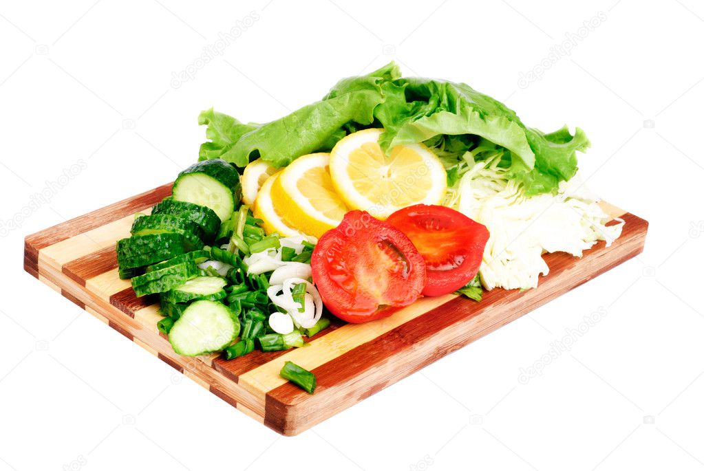 Fresh fruits and vegetables on a bamboo cutting board