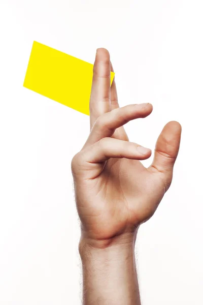 Gele kaart in een hand — Stockfoto