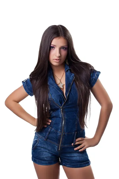 Brunette young woman in jeans overalls — Stock Photo, Image