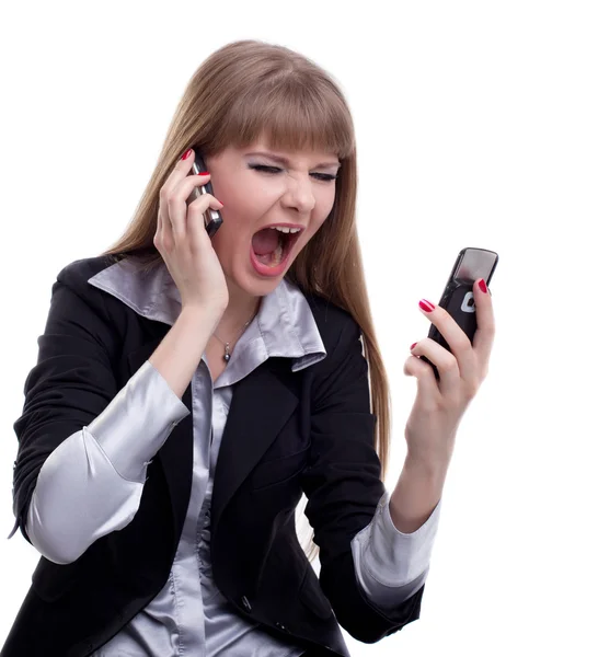Стрессовая деловая женщина с двумя телефонами — стоковое фото