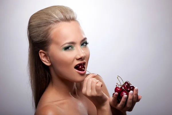 Sexy girl eat cherry look at camera — Stock Photo, Image