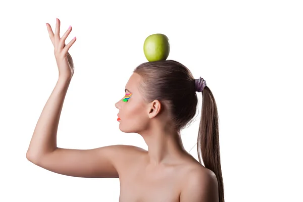Pretty woman take green apple on head — Stock Photo, Image