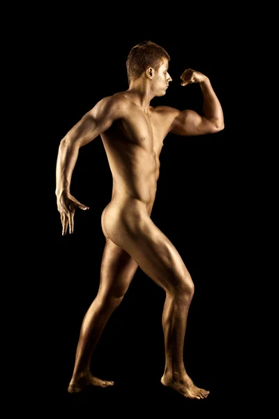 Оголена людина показує спортивне тіло з металевою шкірою — стокове фото