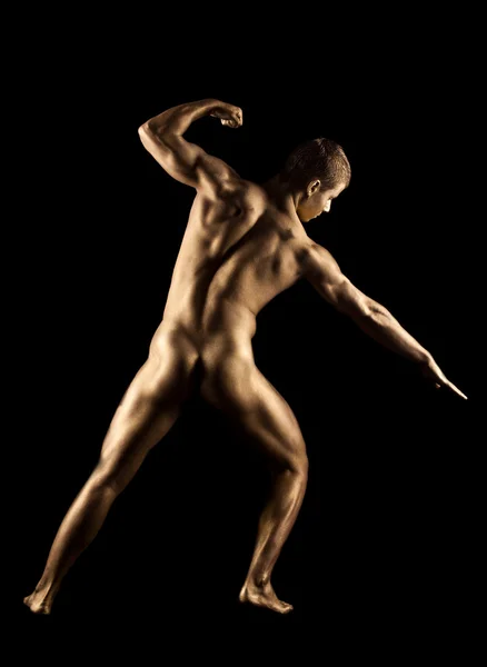 stock image Naked strong man posing in gold skin