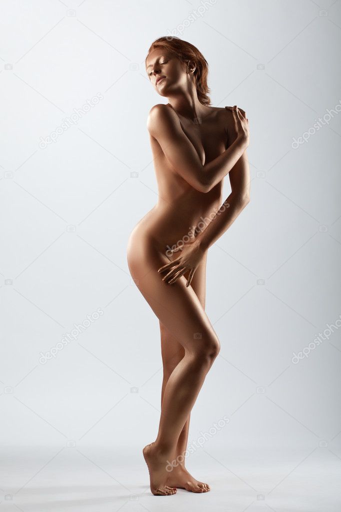 Young woman with perfect body posing naked