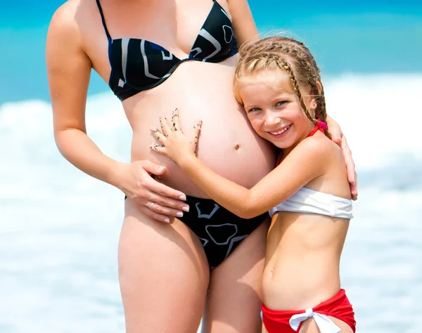 Girl with a stomach of pregnant mother — Stock Photo, Image
