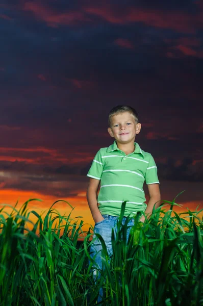 Happy young man rest on green field — Stock Photo, Image