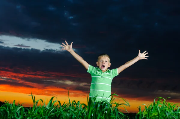 Photo of young boy raising hands in outside — Stock Photo, Image