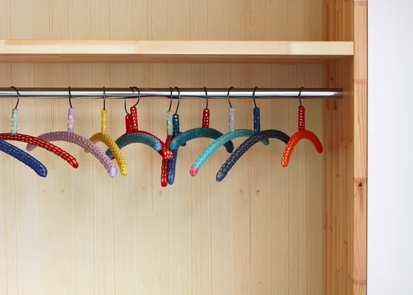 stock image Colorful clothes hangers in closet