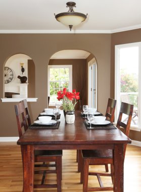 Dining room with brown walls and wood table. clipart