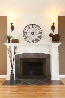 Luxury home white fireplace with stone and clock. clipart